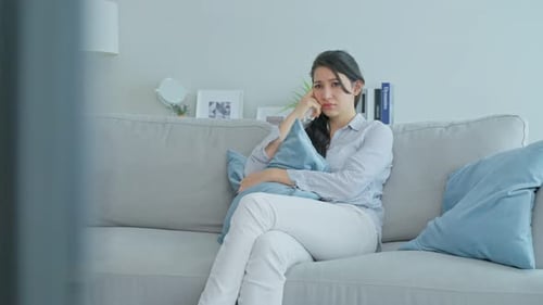 Caucasian loving woman crying in tears watch sad, drama movie on TV in living room in house.