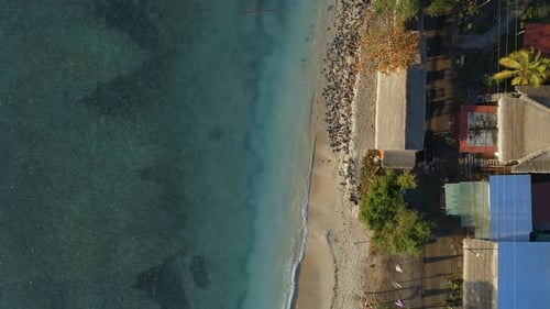 Bird's Eye View of a Picturesque Sandy Beach and Coast With Moored Fishing Boats