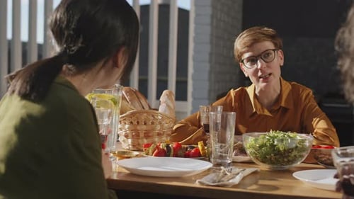 Friends Share a Meal Outdoors on a Sunny Day