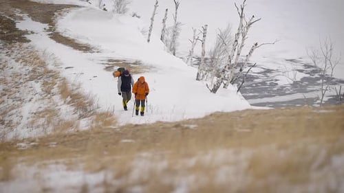 People Hiking Snowy Mountain Landscape in Winter
