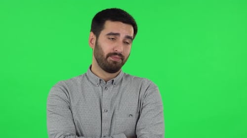 Portrait of Brunette Guy Is Listening To Boring Information and Yawning. Green Screen