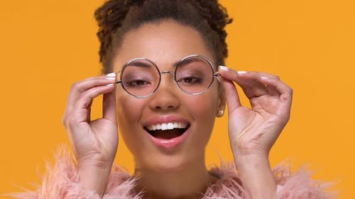 Smiling Woman Puts on Round Glasses
