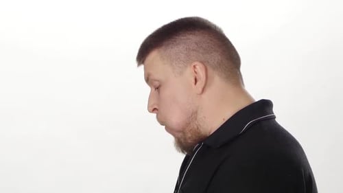 Man Eats Piece of Food on White Background