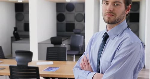 Confident Businessman Standing Proudly in Modern Office