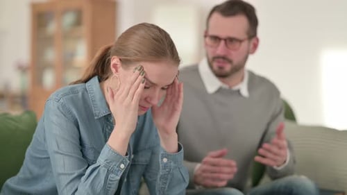 Sad Woman and Man Arguing on Sofa