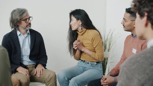 Adults in Group Therapy Talking in Meeting