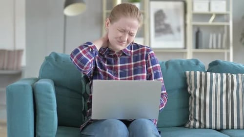 Young Woman with Neck Pain Working on Laptop