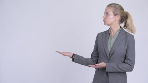 Businesswoman Presenting to Side with Hand Gestures