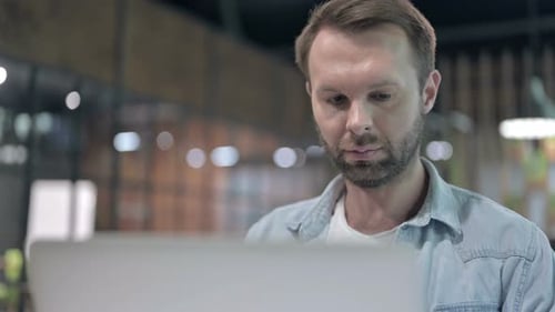 Close Up of Casual Young Man Working on Laptop