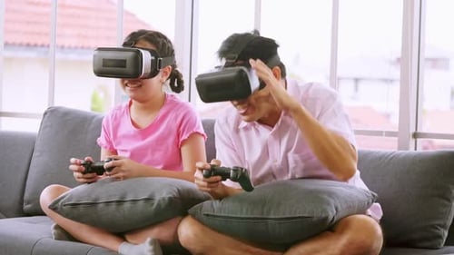 Child and Adult Enjoying Virtual Reality Gaming at Home