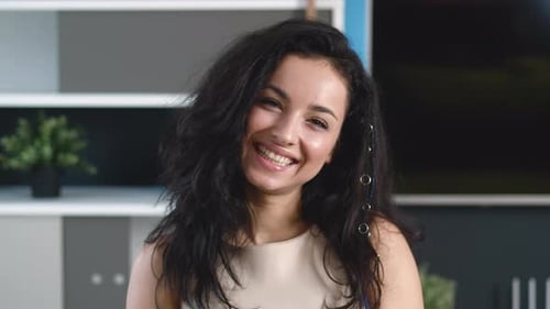 Smiling Young Woman Brunette Looking at Camera at Home Office. Happy Millennial Female with Pretty