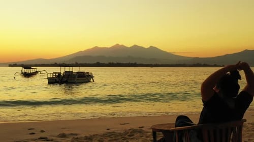 One woman tanning on tropical seashore beach voyage by shallow lagoon with white sand background of