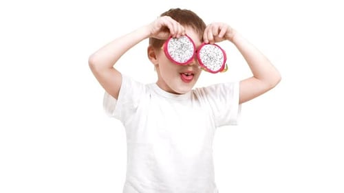 Child Playing with Sliced Dragon Fruit in Studio