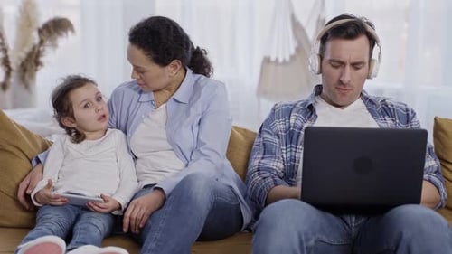 Family Using Technology Relaxing Together at Home