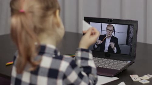 Child Learning Online with a Teacher on Laptop