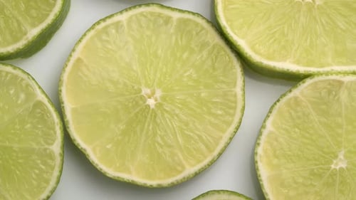 Lime Slices Closeup, Macro Food Summer Background, Fruits Top View. Rotate