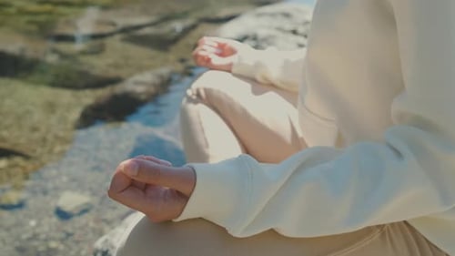 Close Up Woman Practising Yoga in Lotus Posture on the Lake Shore.