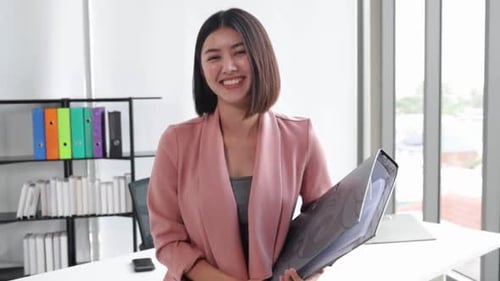 Young Asian business woman in office face portrait smile happy.