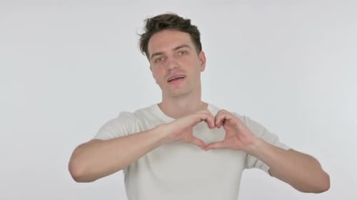 Smiling Young Man Makes Heart Shape With Hands
