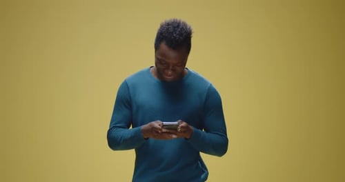 Man Laughing While Using a Smart Phone