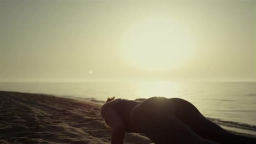 Sporty Girl Training Yoga on Sandy Beach