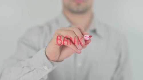 Man Writing BANKER on Glass Close-Up