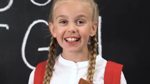 Happy School Girl Expressing Surprise in Classroom