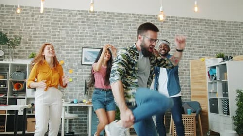 Bearded Guy Dancing in Office While Coworkers Clapping Hands Having Fun Together