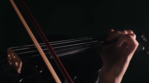 Hands of a Musician Playing the Violin Close-up with Beautiful Lighting