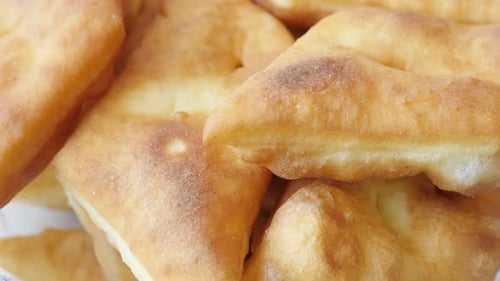 Fried buns made in hot oil served on plate 3840X2160 UltraHD footage - Close-up of golden pirozhki m
