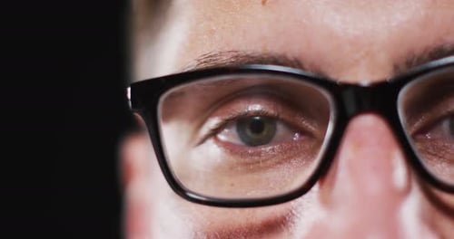 Close up portrait of face of caucasian man wearing glasses with focus on eye