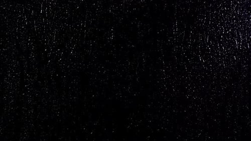 Water drops on glass and black background