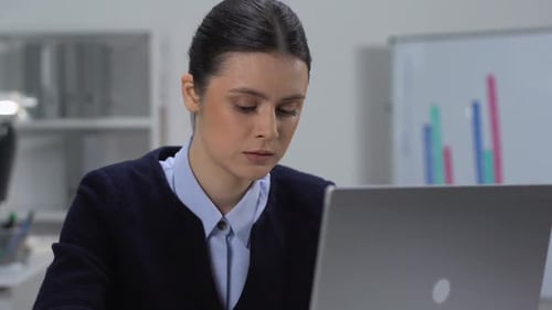 Woman Works at Laptop in Bright Office