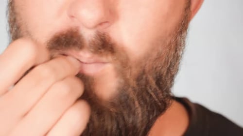 Bearded Man Eating a Potato Chip Close Up
