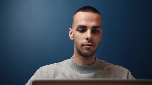 Young Adult Using Laptop at Home