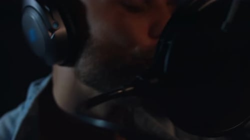 Recording Artist Singing Into Microphone in Sound Booth