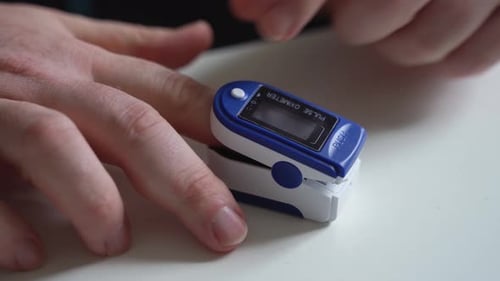 Person Using Fingertip Pulse Oximeter