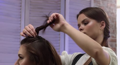 Hairstylist Sections Hair in Salon Setting