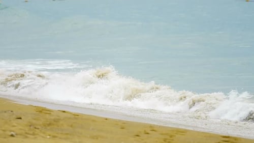 Waves Rolling Gently onto a Sandy Beach