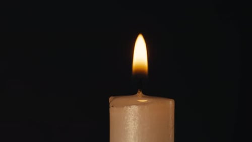 Burning Wax Candle on Black Chroma Key Background