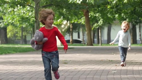 Happy Girl Running It Park with Her Sister Together. Slow Motion