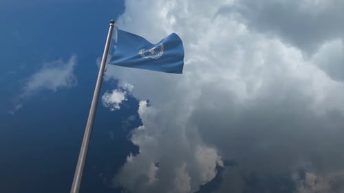 United Nations Flag Waving Against Cloudy Sky