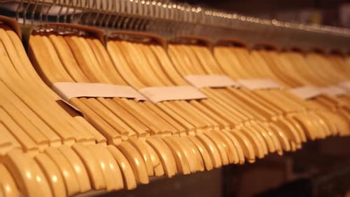 Sets of Vintage Wooden Hangers on Rack in Household Store