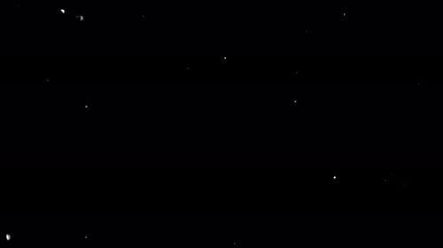 Sparkling White Dust Particles on Black Background