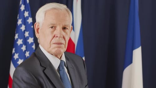 Man in Suit Poses with Flags