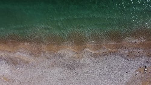 Aerial View From Above on Azure Sea and Pink Pebbles Beach
