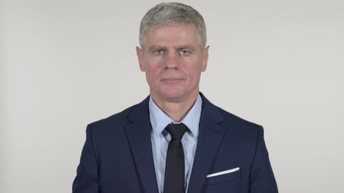 Gray Haired Man Wearing A Blue Suit