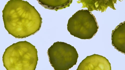 Green Cucumbers and Lettuce Spinning on White Background, Fresh Organic Food