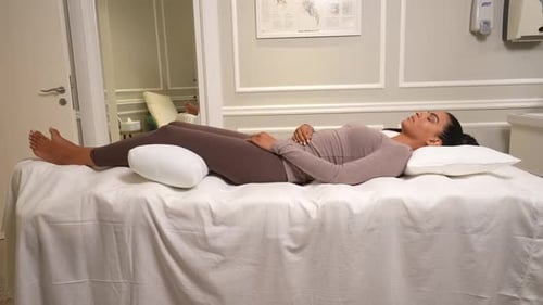Woman Relaxing on Bed in a Doctor's Office