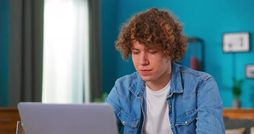 Serious Man Using Laptop Checking Email News Online Sitting on Chair Searching for Friends in